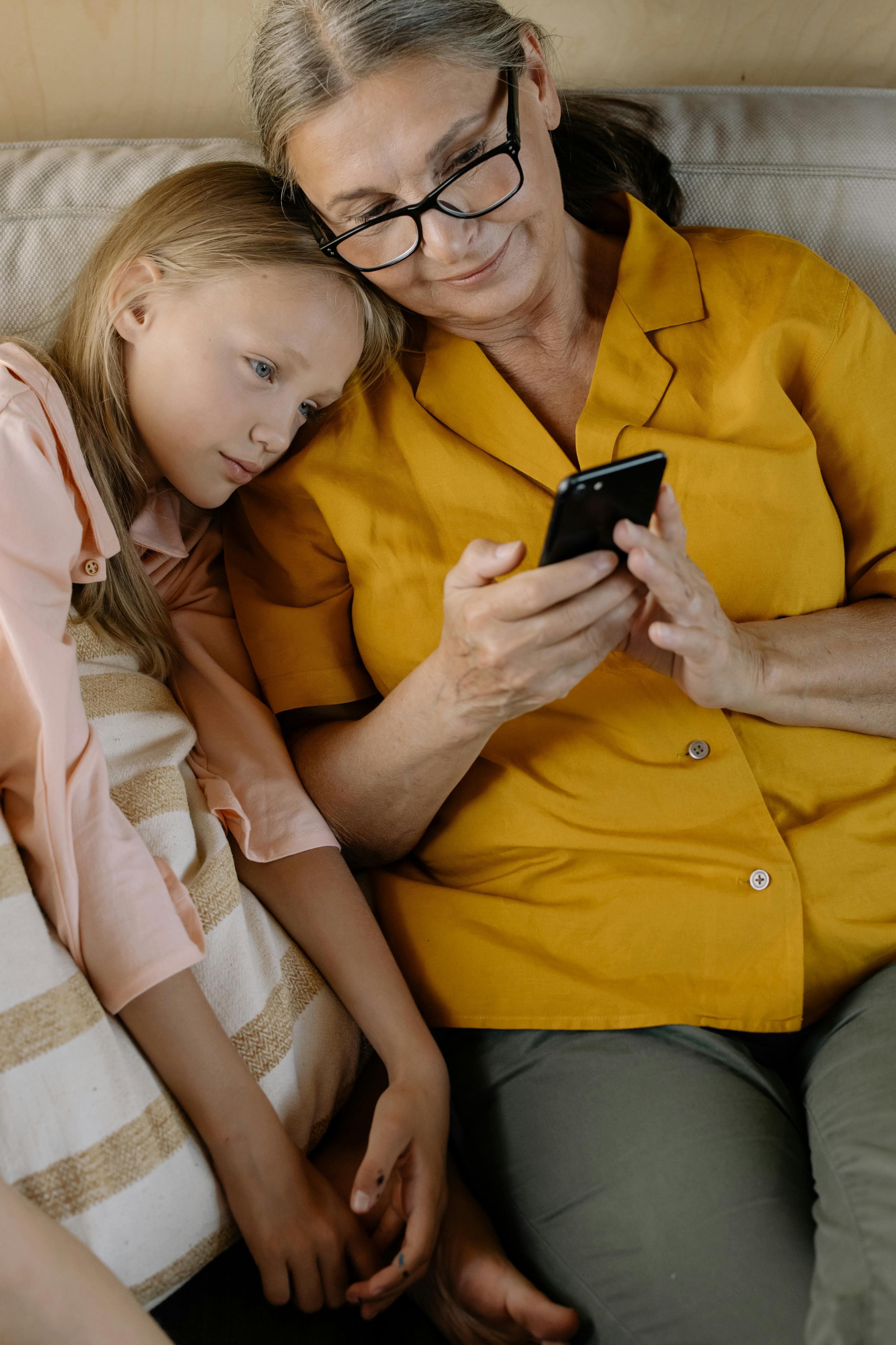 A daughter and her child on the couch at home, reading today's visit note together